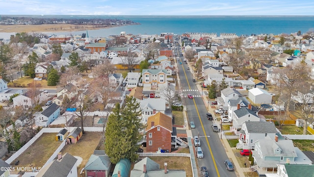 drone / aerial view with a water view and a residential view