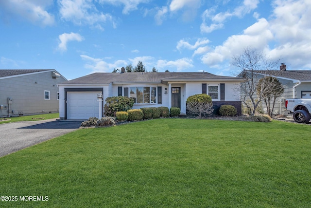 single story home with driveway, a front yard, and a garage