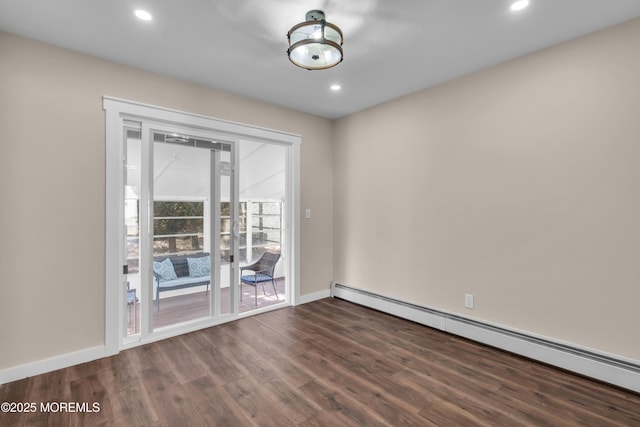 spare room with dark wood-style floors, recessed lighting, a baseboard heating unit, and baseboards