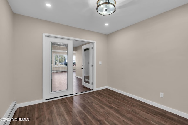 empty room with recessed lighting, baseboards, a baseboard heating unit, and dark wood-type flooring