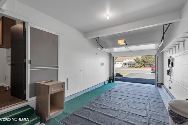 garage with a garage door opener and baseboards