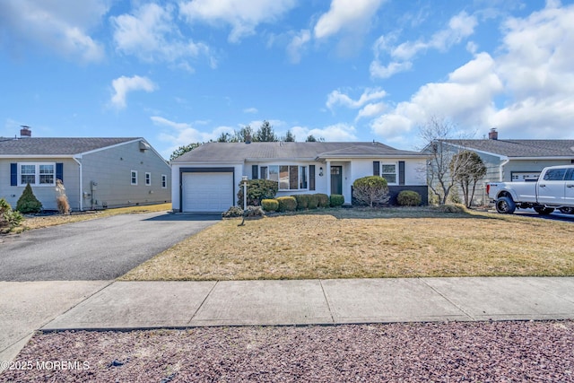 ranch-style house with driveway, a front lawn, and a garage