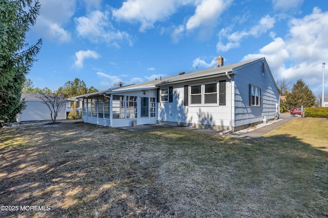 ranch-style home with a front lawn and a sunroom