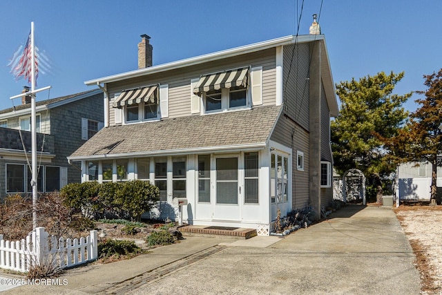 view of front of property featuring a chimney and fence