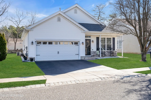 traditional-style home with a front lawn, an attached garage, driveway, and roof with shingles