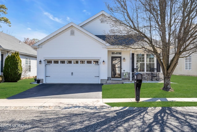 traditional-style home featuring an attached garage, driveway, and a front yard