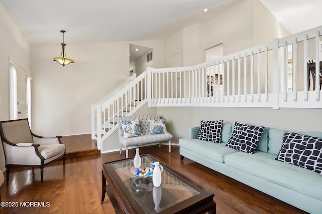 living area with stairs, wood finished floors, visible vents, and recessed lighting