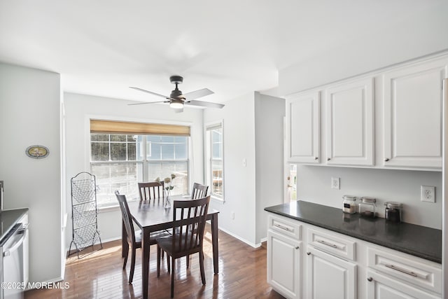 kitchen featuring white cabinets, dark wood-style flooring, dark countertops, baseboards, and a ceiling fan