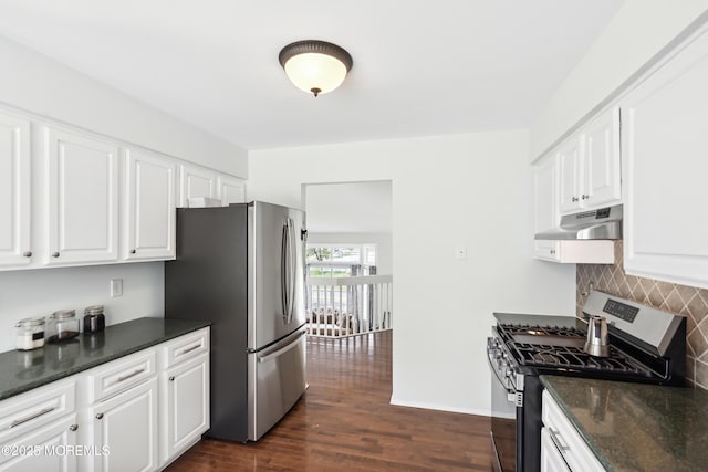 kitchen featuring dark wood finished floors, white cabinets, appliances with stainless steel finishes, backsplash, and under cabinet range hood