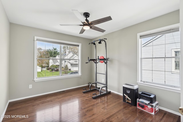 workout room featuring ceiling fan, baseboards, wood finished floors, and visible vents