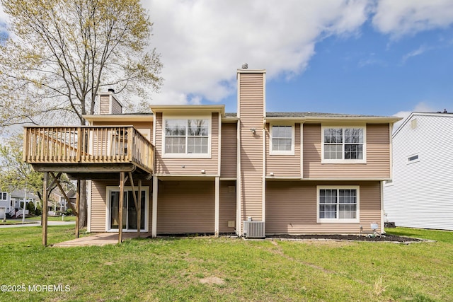 rear view of house with a wooden deck, a lawn, central AC, and a chimney