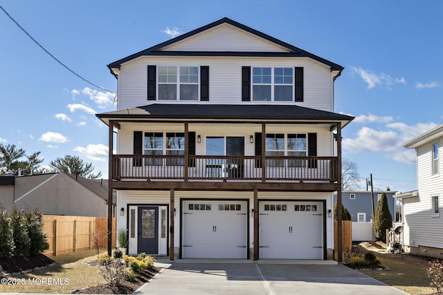 view of front of property featuring a garage, driveway, and fence