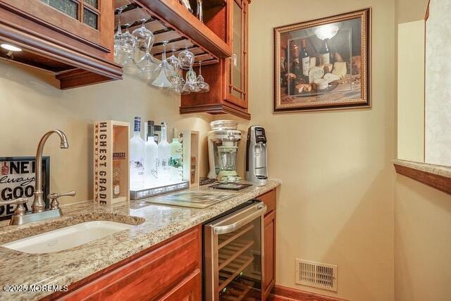 bar featuring a sink, visible vents, wine cooler, and a dry bar