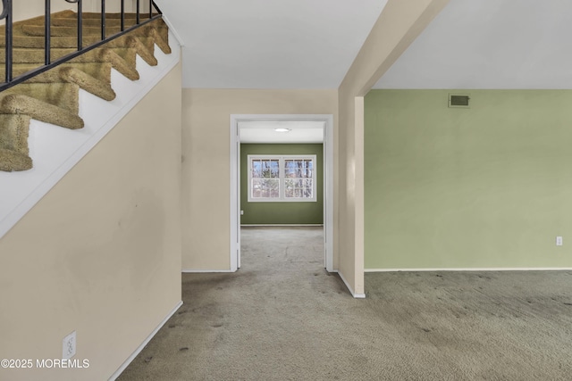 interior space featuring stairs, visible vents, carpet, and baseboards