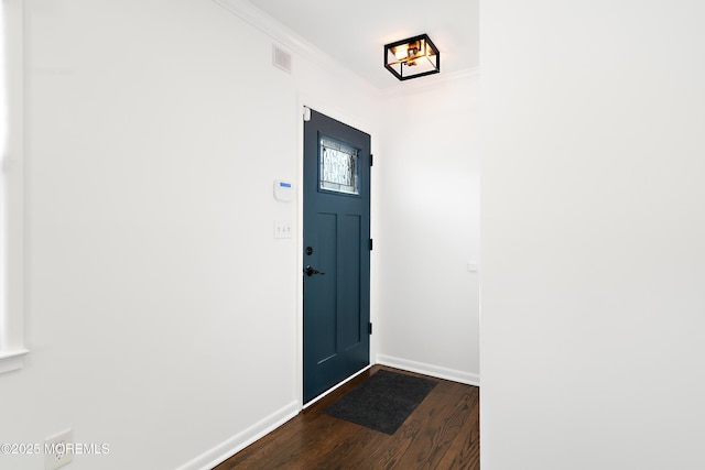 entryway featuring dark wood finished floors, crown molding, baseboards, and visible vents