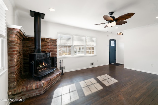 unfurnished living room featuring a ceiling fan, baseboards, visible vents, wood-type flooring, and crown molding