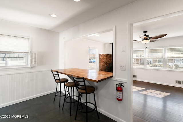 dining space with visible vents, baseboards, ceiling fan, recessed lighting, and wainscoting