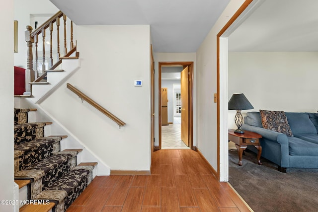 interior space featuring baseboards and wood finished floors