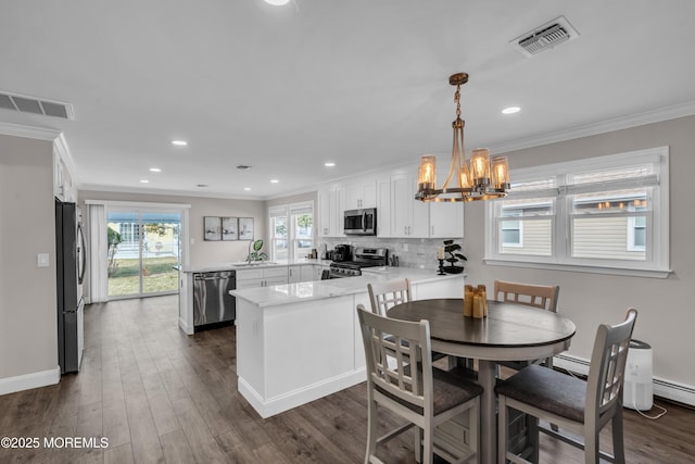 dining space with recessed lighting, visible vents, dark wood-style floors, and ornamental molding