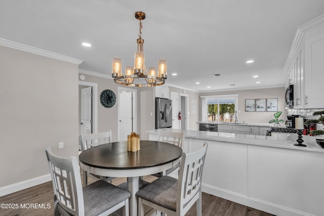 dining room with dark wood finished floors, crown molding, recessed lighting, and baseboards