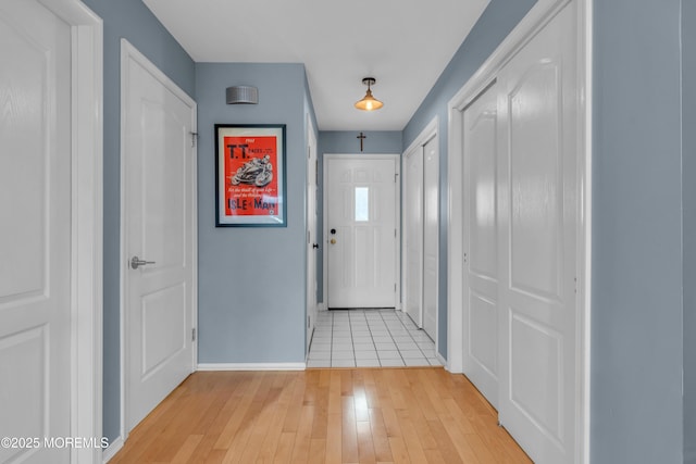 entryway with light wood-style flooring and baseboards