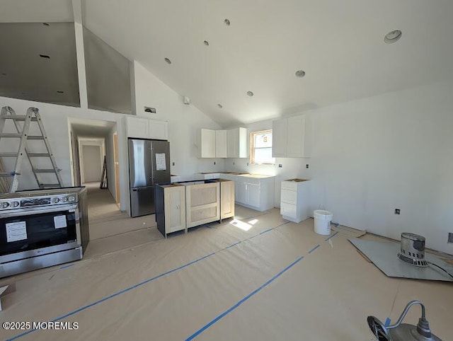 kitchen featuring high vaulted ceiling, a kitchen island, white cabinets, and stainless steel appliances