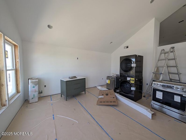 living room with lofted ceiling and stacked washer / drying machine