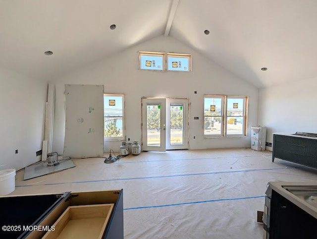 living area featuring beam ceiling and high vaulted ceiling