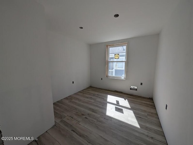 spare room with wood finished floors