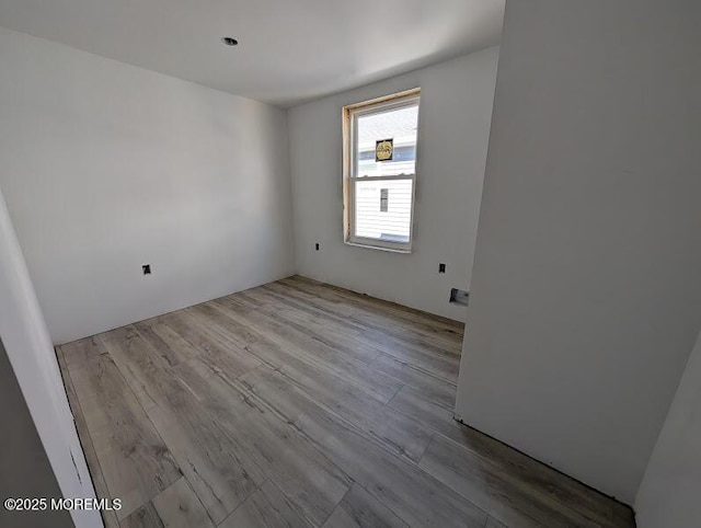 spare room with wood finished floors