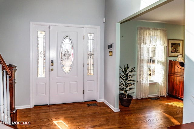 entrance foyer featuring stairway, baseboards, and wood finished floors