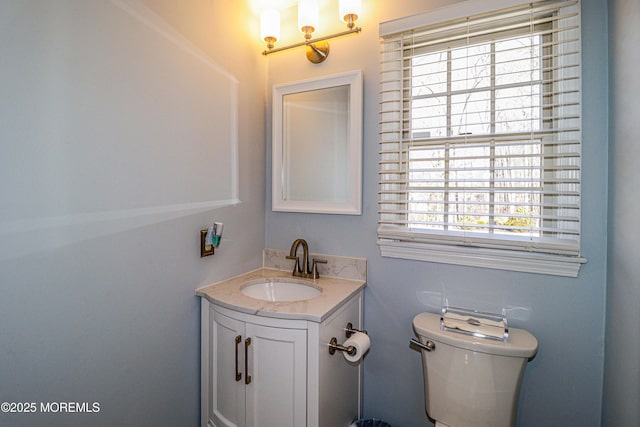 half bath featuring toilet and vanity