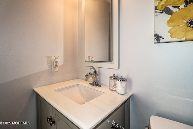 bathroom featuring toilet and vanity