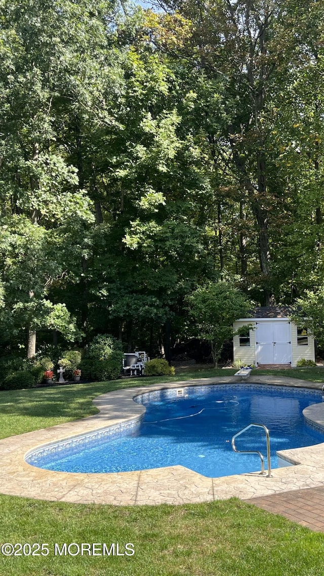 outdoor pool featuring a storage shed and an outdoor structure