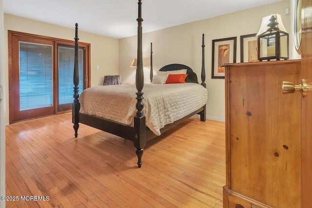 bedroom with light wood-style flooring and baseboards