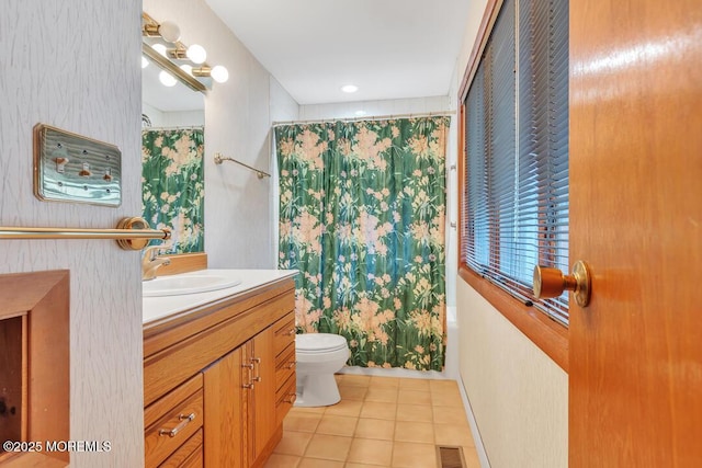 full bathroom featuring vanity, visible vents, tile patterned flooring, shower / tub combo, and toilet