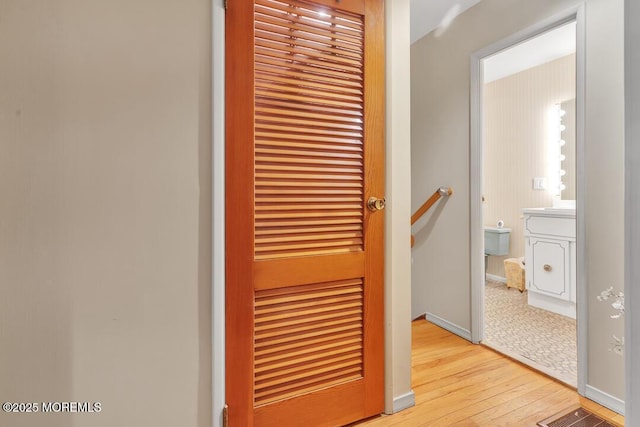 details featuring wood finished floors, visible vents, and baseboards