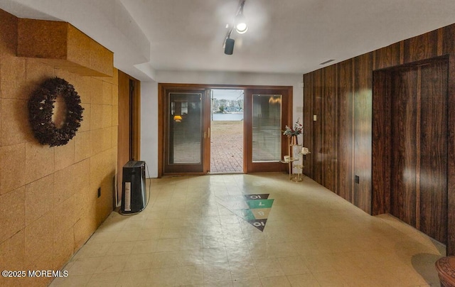 hallway with wooden walls and light floors