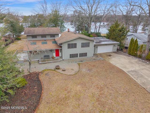 view of front of property with a garage, driveway, and stucco siding