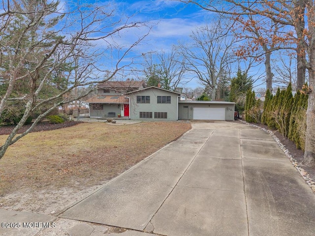 view of front of home with a garage, driveway, and a chimney