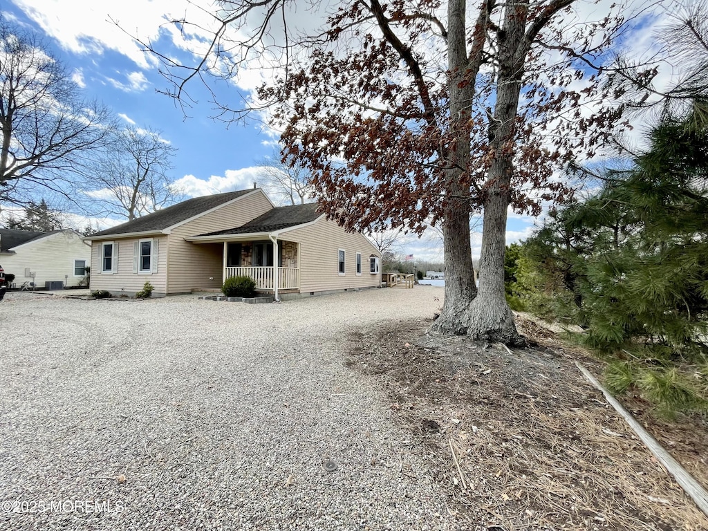 rear view of house with crawl space and covered porch