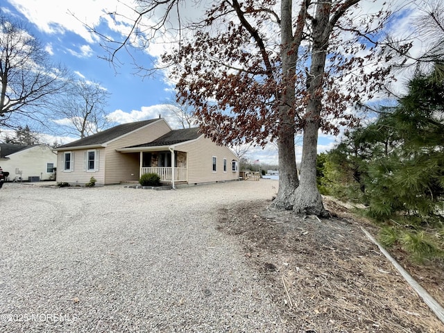 rear view of house with crawl space and covered porch