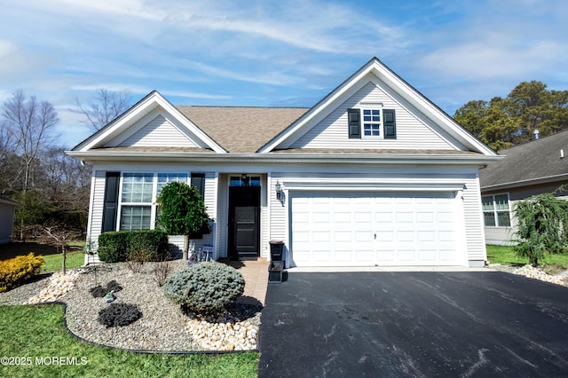 ranch-style home with an attached garage, driveway, and a shingled roof