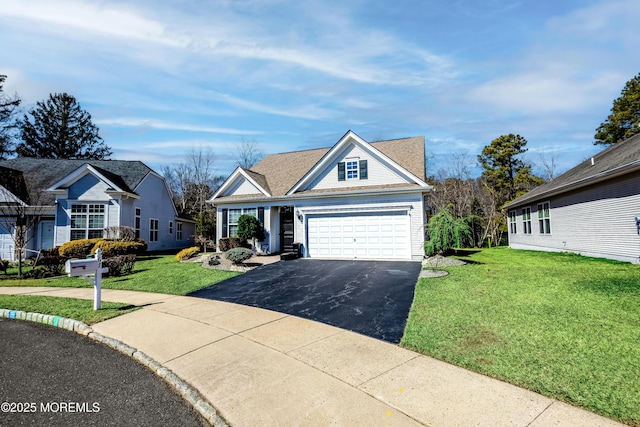 view of front of house with a front yard, a garage, and driveway