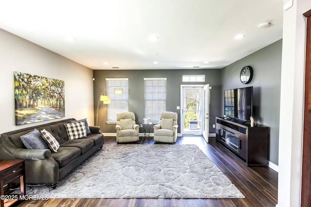 living room featuring dark wood-style floors, recessed lighting, and baseboards