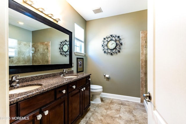 full bath with baseboards, visible vents, a tile shower, and a sink