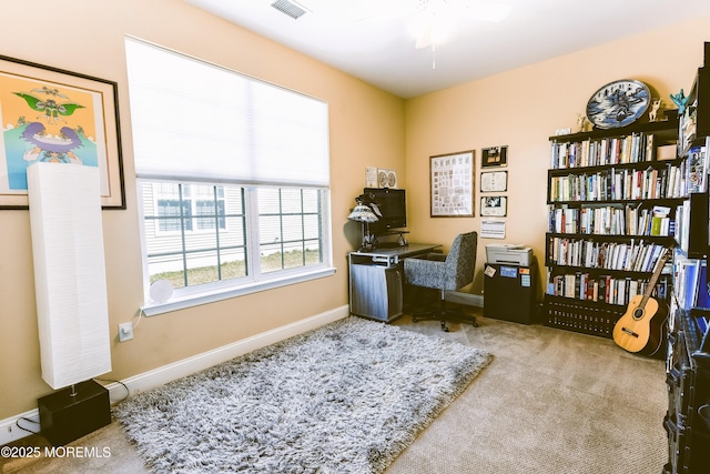 carpeted office space featuring visible vents and baseboards