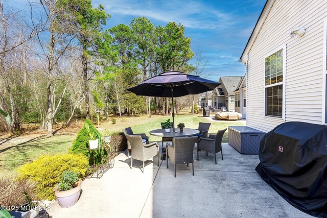 view of patio with area for grilling and outdoor dining area