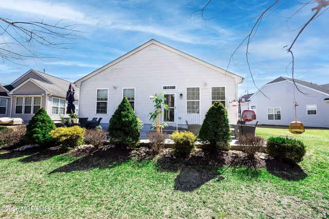 back of property featuring a patio, a lawn, and entry steps