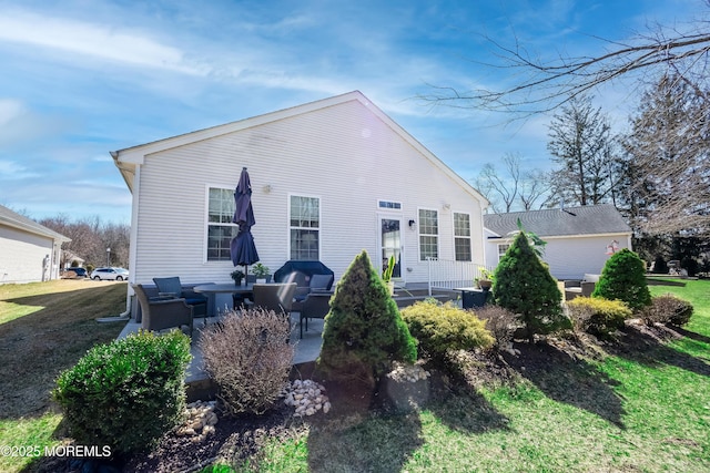 back of property with a patio area, a lawn, and an outdoor hangout area